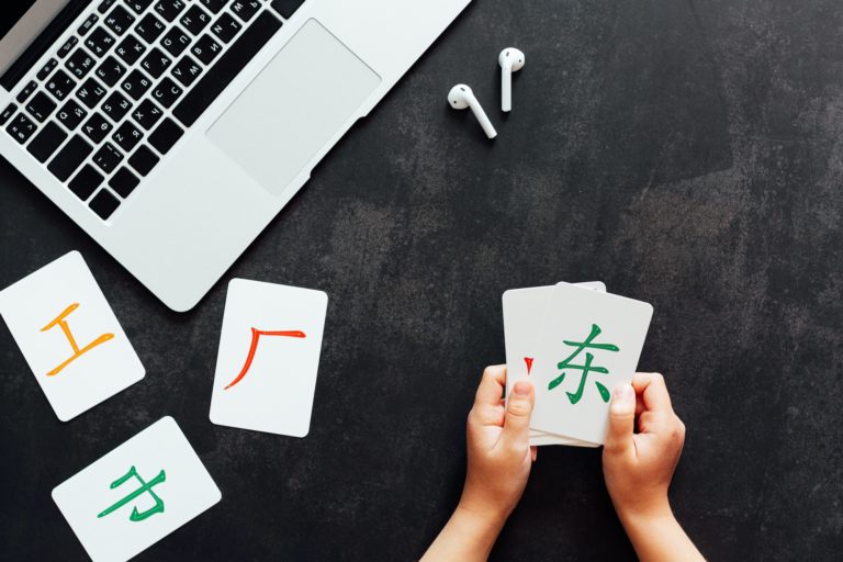 Flat lay mockup for online courses of Chinese language. Laptop and cards with basic printed